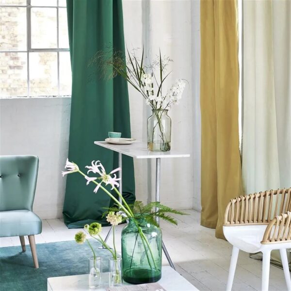 plain silk-satin curtain from Designers Guild and side table and chairs