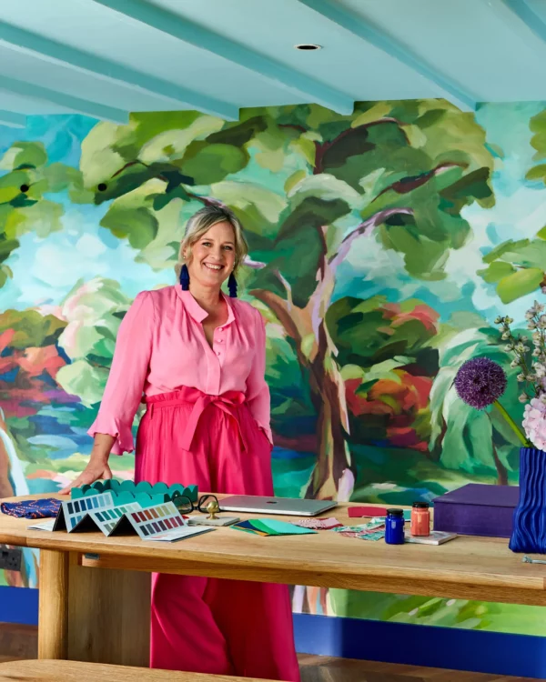Dahlia Bunch Wallpaper - Lapis by sophie robinson at table with colour charts and samples