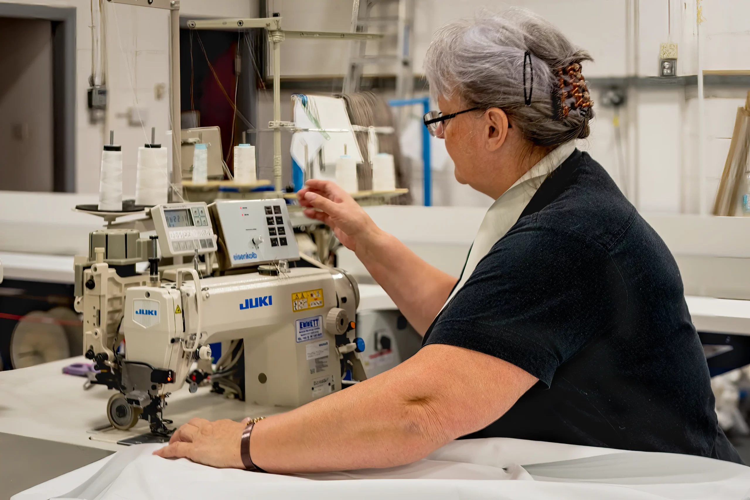 feeding fabric through a sewing machine