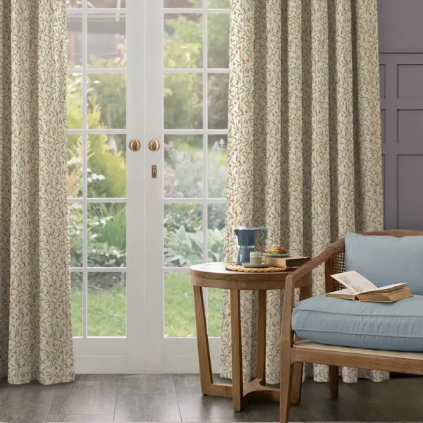 Bell Meadow Fabric - Rosewood by neutral floral curtains with green leaves and purple flowers at a french door. wooden armchair with blue cushions with matching wooden side table