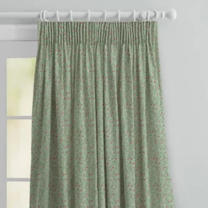 top half of green floral curtains with pink flowers in pencil pleat heading on a white wooden pole