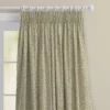 top half of sage green floral curtains with pencil pleat heading. On a white wooden pole
