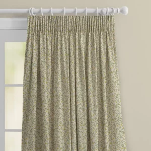 top half of sage green floral curtains with pencil pleat heading. On a white wooden pole