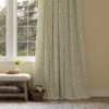 bottom half of sage green floral curtains with a footstool and wooden basket