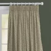 top half of sage green floral curtains on a white wooden curtain pole