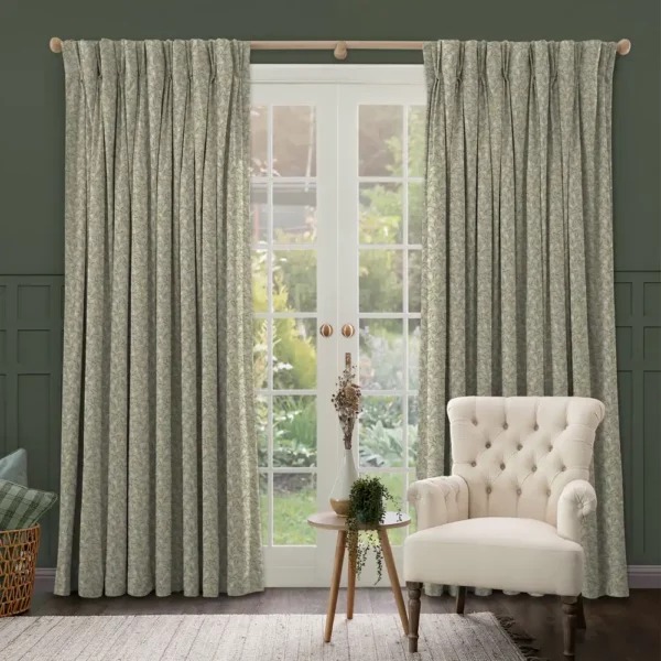 Bell Meadow Fabric - Hazel by sage green floral curtains at a set of french doors with a white armchair and wooden table