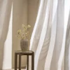 white striped curtain with side table