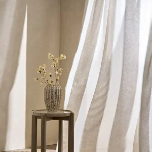 white striped curtain with side table