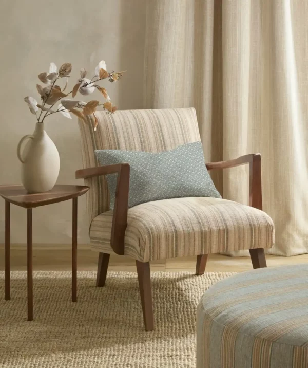 Ingo Fabric - Caper by green striped armchair with cushion and pouf