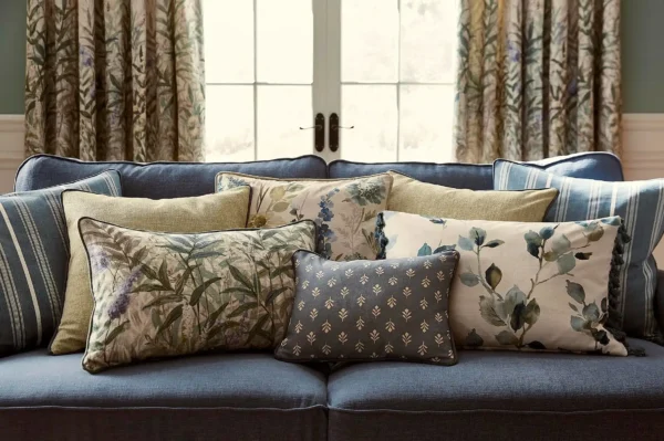 Breton Fabric - Cloud by blue striped cushion with sofa and curtain