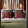 red striped cushion with bed and curtain