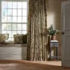 green botanical cushion with curtain and window