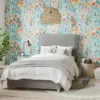 overgrown meadow flowers wallpaper with bed