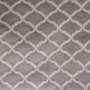 white geometric embroideried fabric from Clarke & Clarke