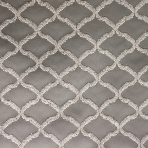 Reggio Fabric - Pebble by white geometric embroideried fabric from Clarke & Clarke