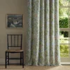 green botanical curtain with window and chair