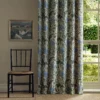 blue botanical curtain with window and chair