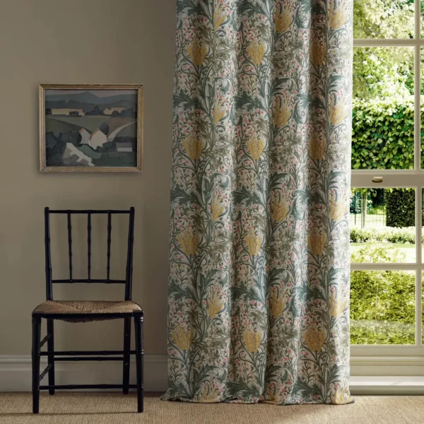 Lent Lily Embroidery Fabric - Artichoke / Weld by yellow botanical curtain with window and chair