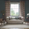 green botanical curtain with cushion and sofa