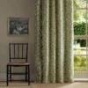 green botanical curtain with window and chair
