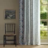 blue botanical curtain with window and chair