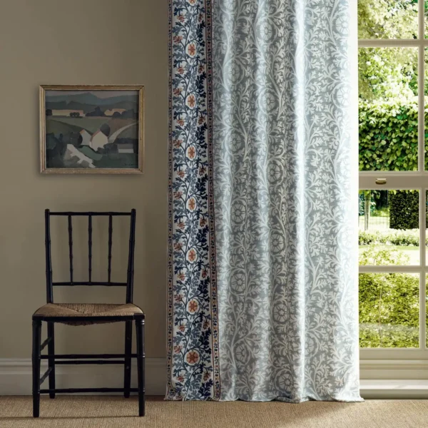 Chamomile Embroidery Fabric - Woad by blue botanical curtain with window and chair