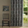 orange botanical curtain with window and chair
