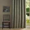 green botanical curtain with window and chair