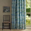 blue botanical curtain with window and chair