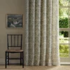 green botanical curtain with window and chair