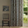 red botanical curtain with window and chair