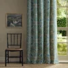 blue botanical curtain with window and chair