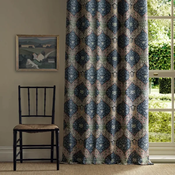blue botanical curtain with window and chair