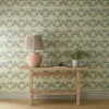 green botanical wallpaper and wall with side table and vases