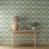 blue botanical wallpaper and wall with side table and vases