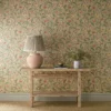 yellow botanical wallpaper and wall with side table and vases