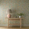multicolour botanical wallpaper and wall with side table and vases