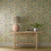 multicolour botanical wallpaper and wall with side table and vases