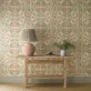 yellow botanical wallpaper and wall with side table and vases