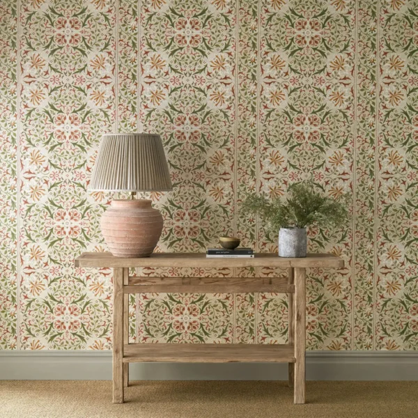 Walthamstow Wallpaper - Rose / Nettle by yellow botanical wallpaper and wall with side table and vases