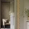 yellow botanical wallpaper and wall with chair and door