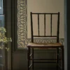 blue botanical wallpaper and wall with chair and door