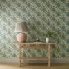 blue botanical wallpaper and wall with side table and vases