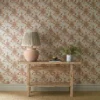 blue botanical wallpaper and wall with side table and vases