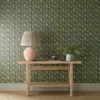 green botanical wallpaper and wall with side table and vases