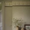 neutral botanical wallpaper and wall with vases and door