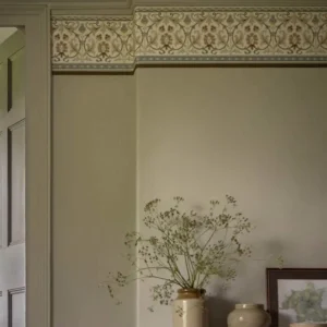 neutral botanical wallpaper and wall with vases and door