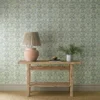 blue botanical wallpaper and wall with side table and vases