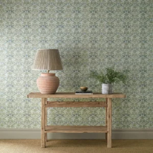 blue botanical wallpaper and wall with side table and vases