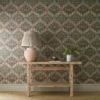 green botanical wallpaper and wall with side table and vases